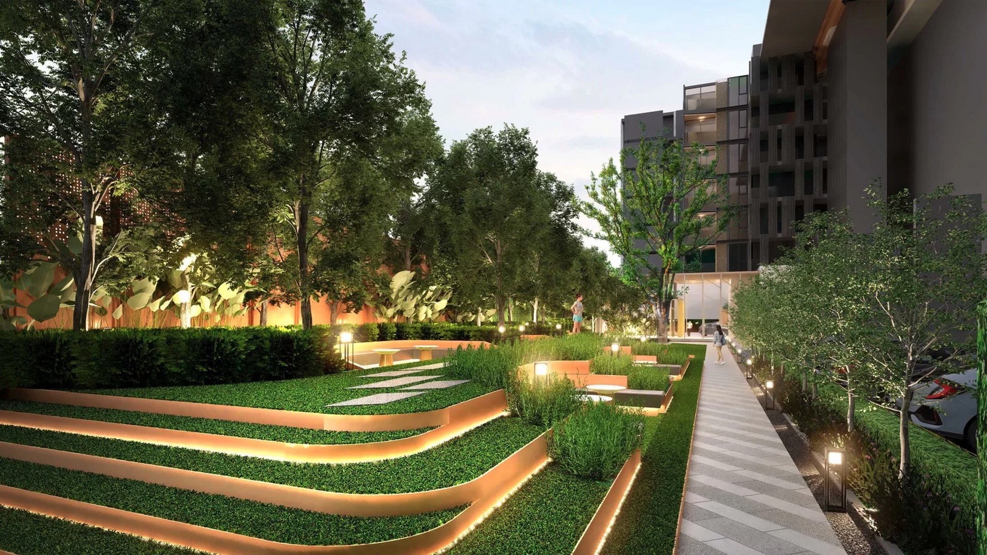 VIP Venus Karon — landscaped garden walkway with terraced lawns at dusk