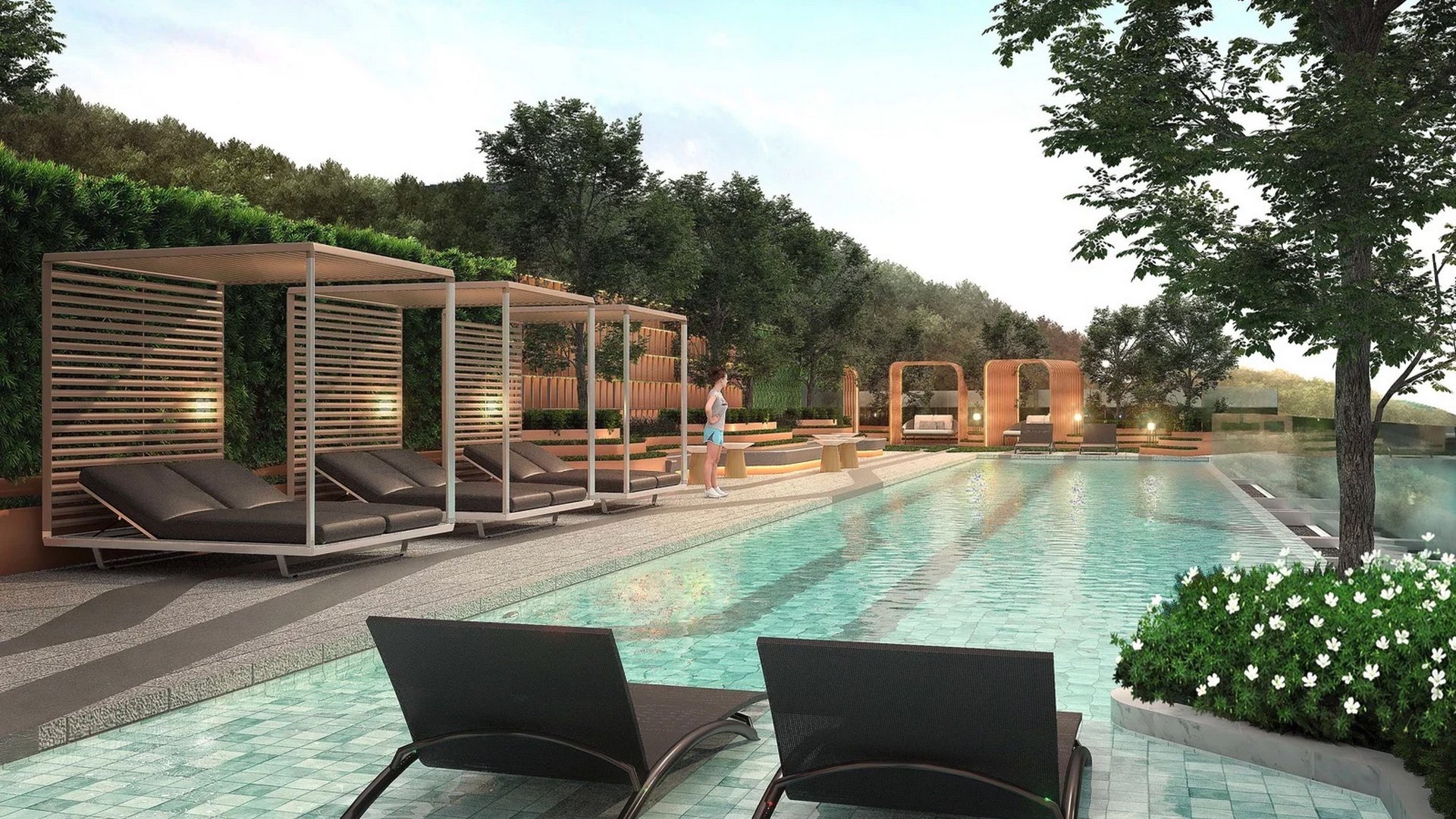 VIP Venus Karon — pool deck with timber cabanas and sun loungers facing the lap pool
